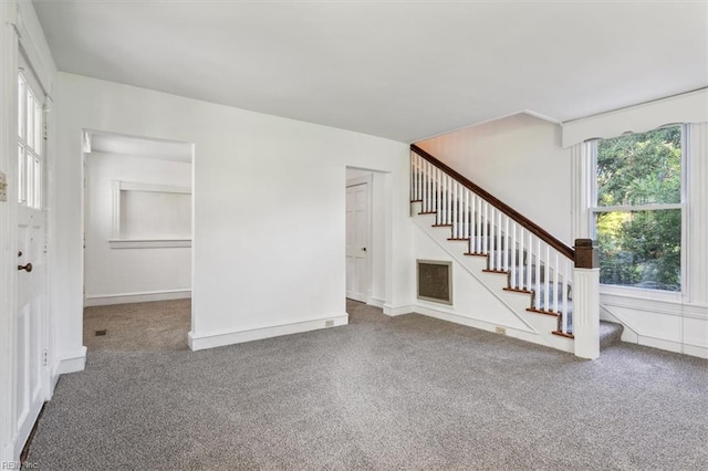 unfurnished living room featuring carpet floors