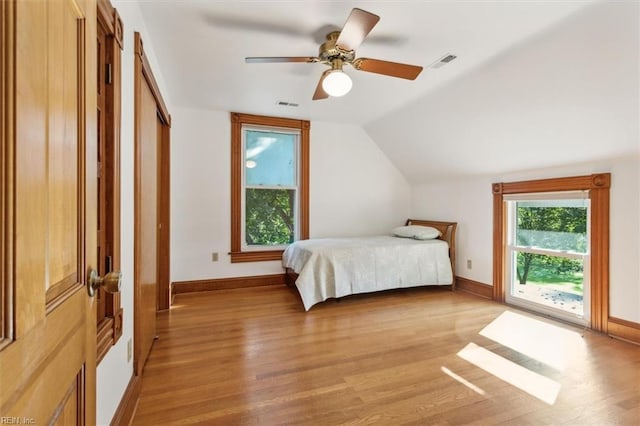 bedroom featuring ceiling fan, vaulted ceiling, and light wood-type flooring