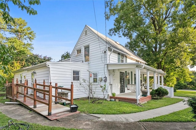 rear view of property with a lawn