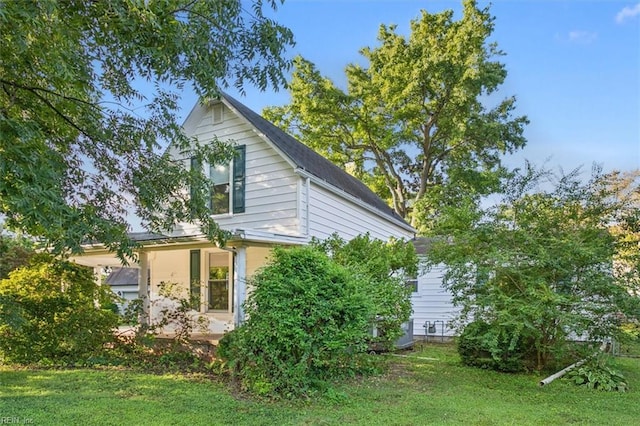 view of side of property with a yard