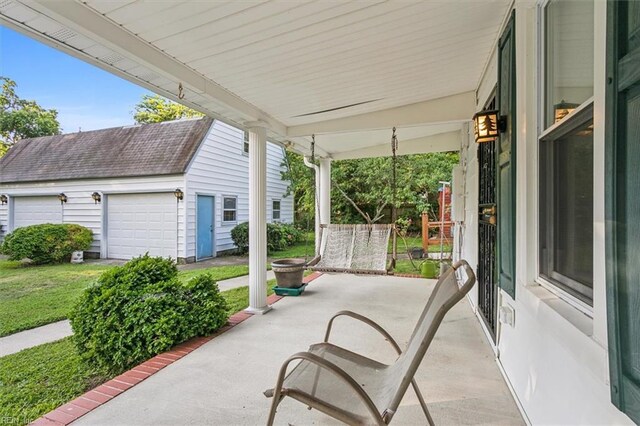 view of patio / terrace with an outdoor structure and a garage