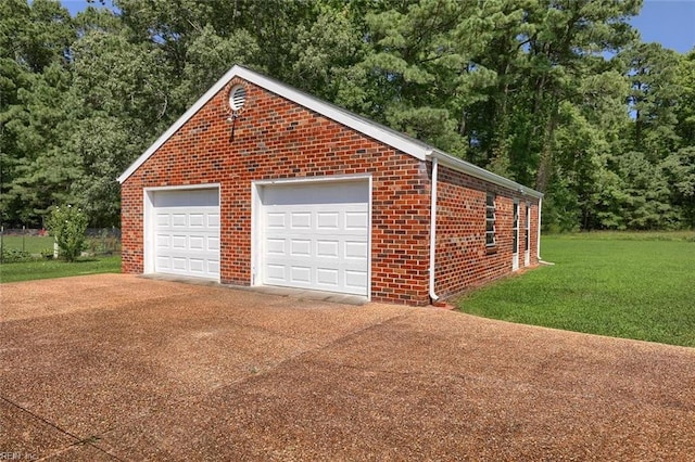 garage featuring a lawn