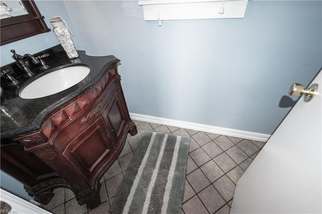 bathroom featuring tile patterned floors, baseboards, and vanity