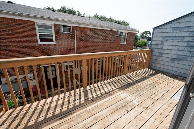 wooden terrace with a wall mounted air conditioner