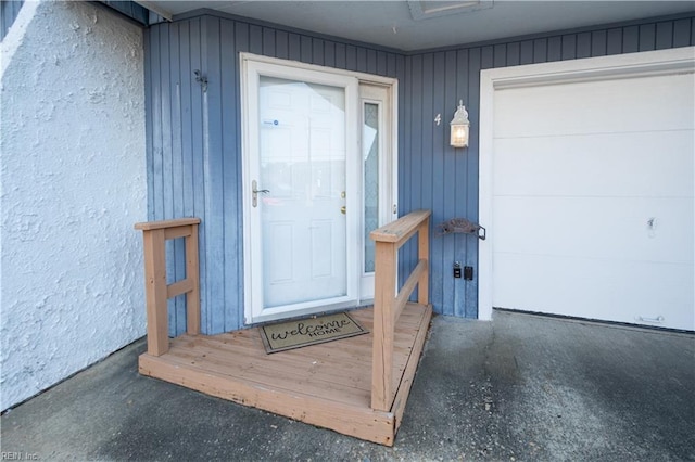 view of exterior entry with a garage