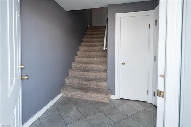 staircase with tile patterned flooring and baseboards