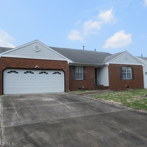 single story home with a garage and a front yard