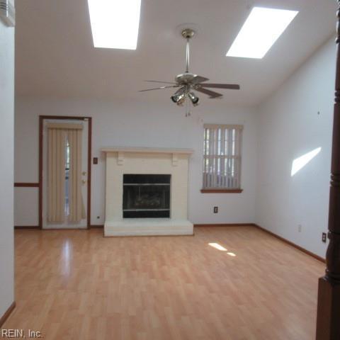 hall with light hardwood / wood-style flooring and a healthy amount of sunlight