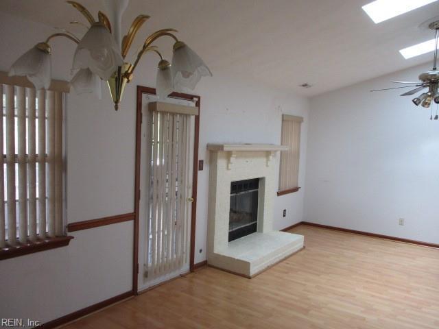 unfurnished living room with ceiling fan and wood-type flooring