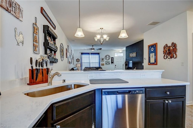 kitchen with light countertops, visible vents, open floor plan, a sink, and dishwasher