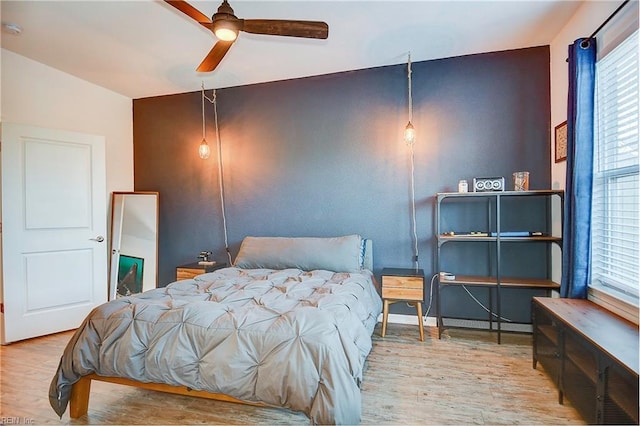 bedroom featuring ceiling fan and wood finished floors