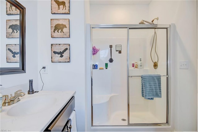 bathroom featuring a shower stall and vanity