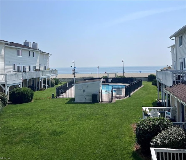 view of yard with a water view and a fenced in pool