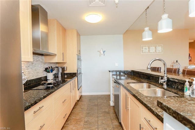 kitchen with stainless steel appliances, sink, hanging light fixtures, light tile patterned flooring, and wall chimney range hood