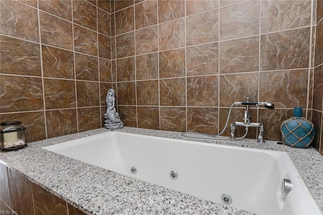 bathroom with tile walls and tiled bath