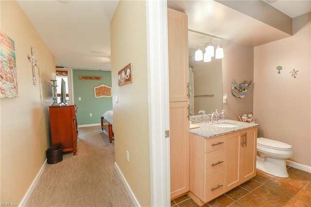 bathroom featuring tile patterned flooring, vanity, and toilet