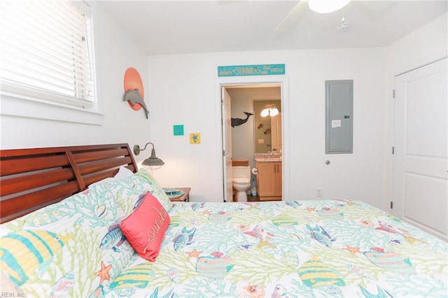 bedroom featuring ceiling fan, electric panel, and connected bathroom