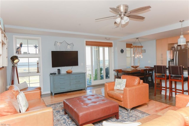 tiled living room with ceiling fan