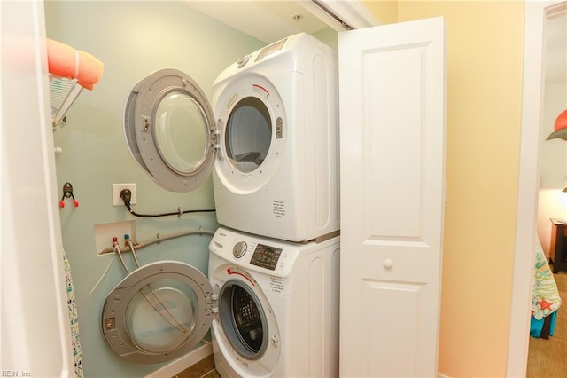 washroom featuring stacked washer / dryer