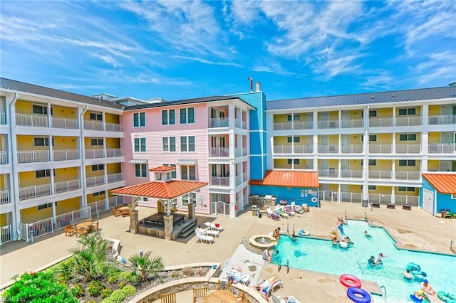 view of building exterior featuring a community pool