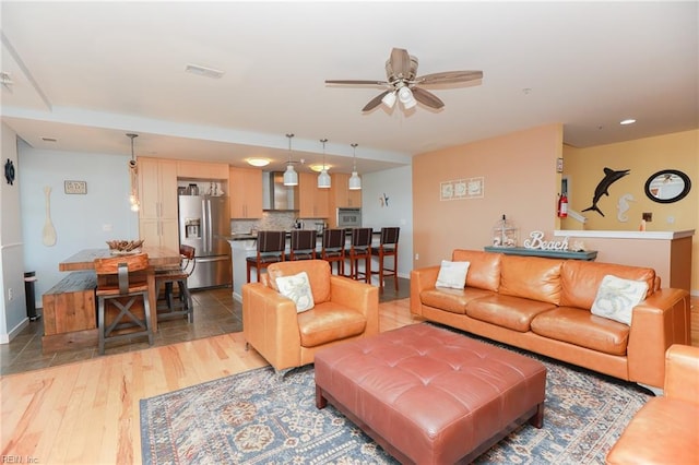 tiled living room featuring ceiling fan