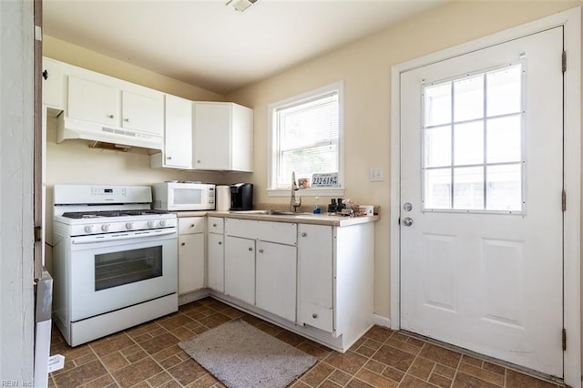 kitchen featuring white cabinetry, white appliances, and sink