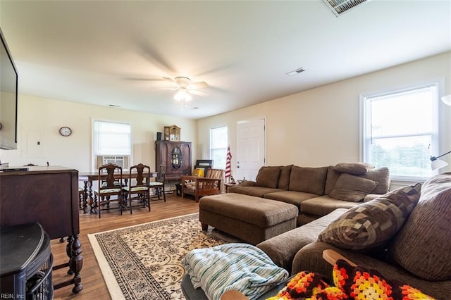 living room featuring cooling unit, ceiling fan, light hardwood / wood-style floors, and a healthy amount of sunlight