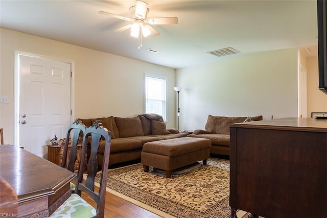 living room with ceiling fan and hardwood / wood-style floors