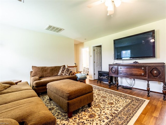 living room with hardwood / wood-style floors and ceiling fan