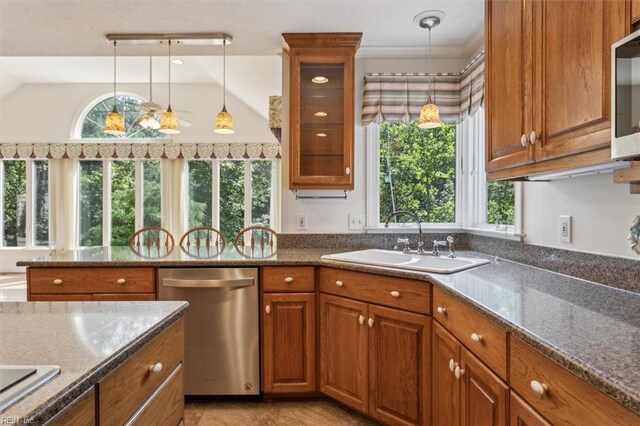 kitchen featuring pendant lighting, light stone counters, sink, and appliances with stainless steel finishes