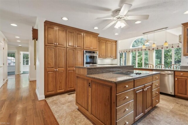 unfurnished living room featuring ceiling fan, ornamental molding, sink, and light hardwood / wood-style flooring