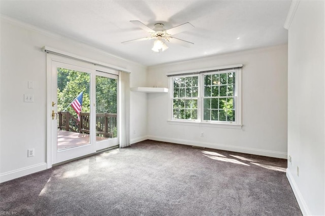 carpeted spare room with a healthy amount of sunlight, ceiling fan, and ornamental molding