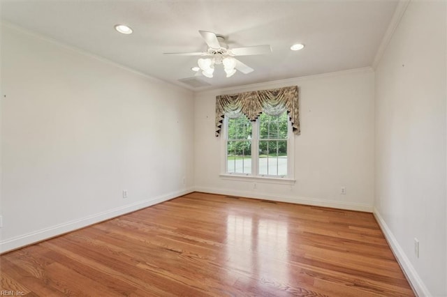 empty room with baseboards, wood finished floors, and ornamental molding