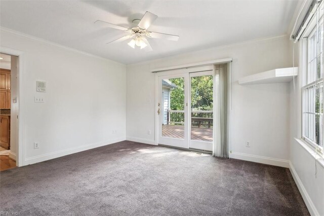 carpeted empty room featuring ceiling fan and crown molding