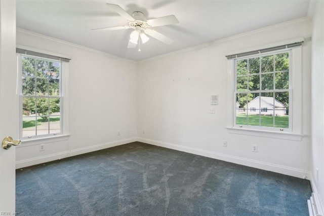 spare room featuring ceiling fan, baseboards, dark colored carpet, and ornamental molding