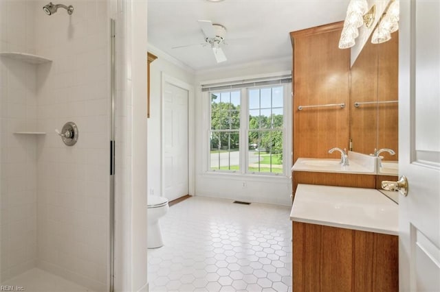 full bathroom featuring visible vents, ceiling fan, a tile shower, tile patterned floors, and vanity