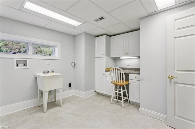 laundry area with washer hookup, baseboards, and visible vents