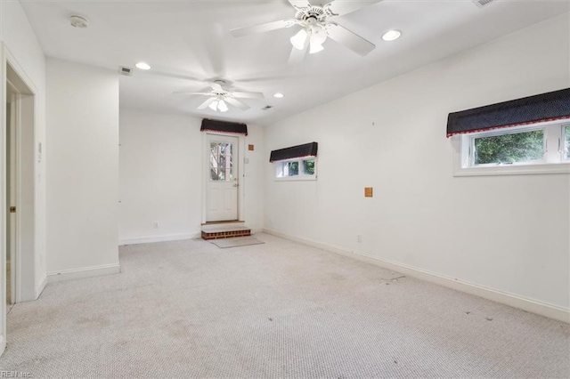 carpeted spare room featuring visible vents, recessed lighting, baseboards, and ceiling fan