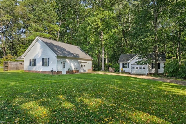 exterior space featuring an outdoor structure, a lawn, and fence