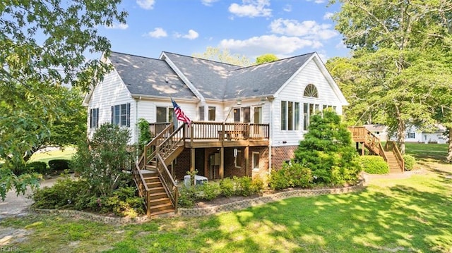 back of house with a yard, brick siding, a wooden deck, and stairs