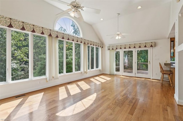 unfurnished sunroom with ceiling fan and vaulted ceiling