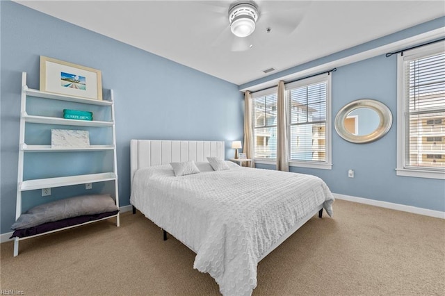 bedroom featuring visible vents, carpet flooring, a ceiling fan, and baseboards