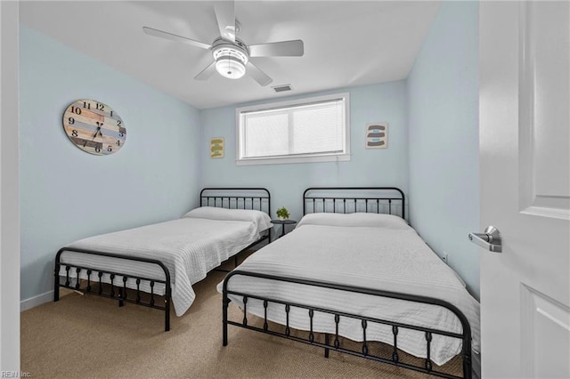 bedroom with carpet floors, ceiling fan, visible vents, and baseboards