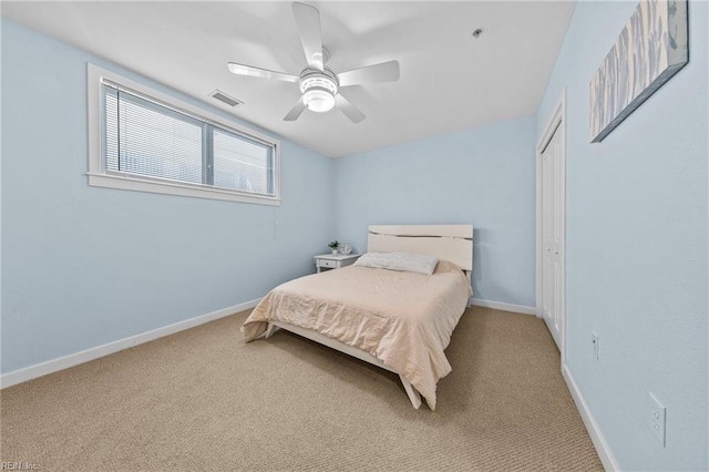 carpeted bedroom with a closet, visible vents, ceiling fan, and baseboards