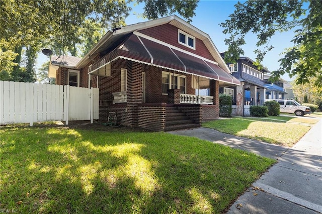 view of front of property with a front yard and a porch