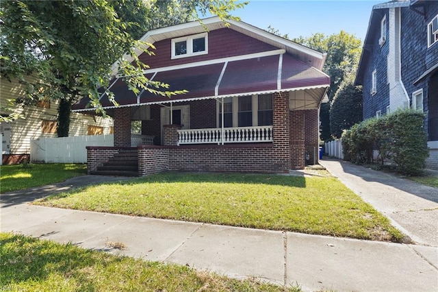 bungalow-style home featuring a front lawn and covered porch