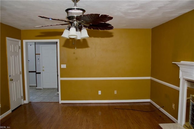 6703 Chambers Ln, Suffolk, VA 23435 - unfurnished living room featuring a ceiling fan, baseboards, wood finished floors, and a fireplace