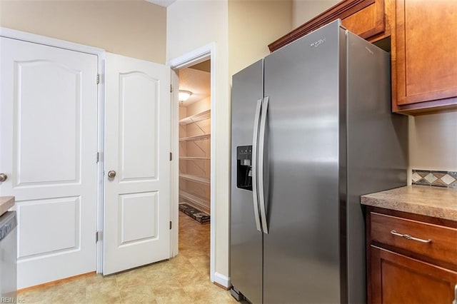 kitchen featuring appliances with stainless steel finishes and brown cabinets