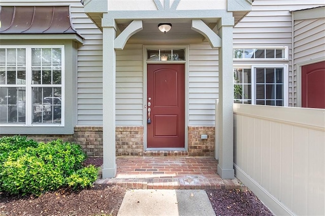 doorway to property with brick siding