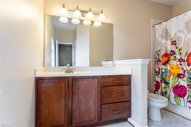 bathroom with curtained shower, vanity, and toilet